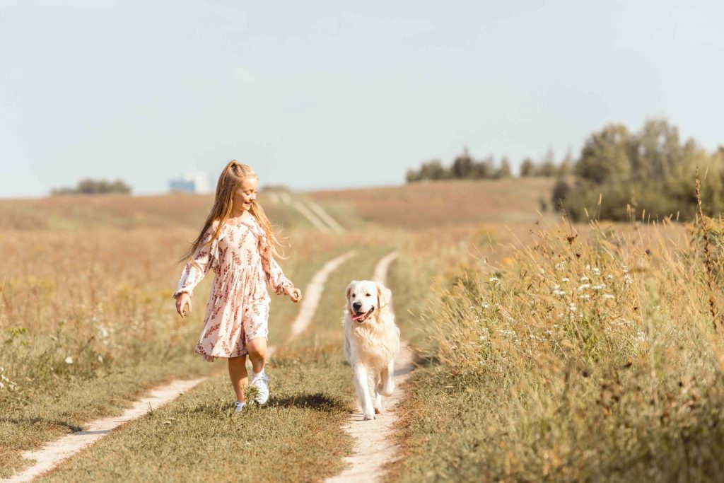 girl walking with dog after qlf surgery